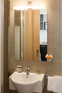 a bathroom with a sink and a mirror at Homz AH02 Kolonaki Penthouse Studio in Athens