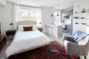 a bedroom with a large bed and a kitchen at Callisto in Washington, D.C.