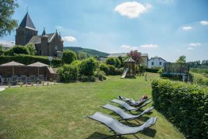 a group of lounge chairs sitting on a lawn at Haus Engel in Burg-Reuland