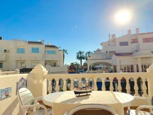 a table and chairs on a balcony with buildings at Apartamento Sun Beach in Benalmádena