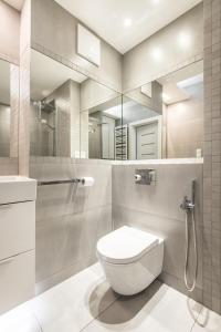 a bathroom with a toilet and a shower and a sink at Super-Apartamenty Love Deluxe in Poznań +30 photos