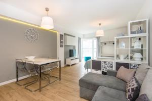 a living room with a couch and a table at Super-Apartamenty Love Deluxe in Poznań