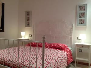a bedroom with a red and white bed with two lamps at Apartment luxury complex near the sea in Adeje +41 photos