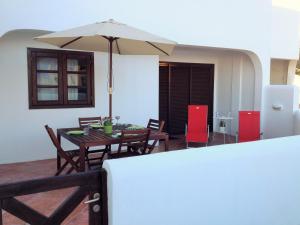 a dining room with a table and an umbrella at Apartment luxury complex near the sea in Adeje