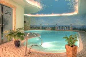a large swimming pool with a painting on the wall at SEETELHOTEL Ostseehotel Ahlbeck in Ahlbeck