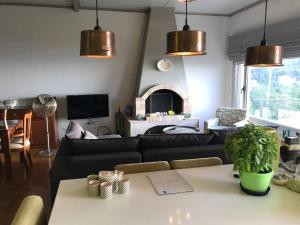 a living room with a couch and a table at Aegean Breeze Mansion in Kymi