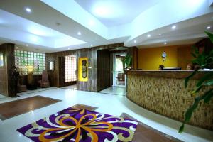 a lobby with a bar and a rug on the floor at La Cour Hotels and Apartments Cooper in Lagos