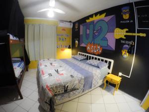 a bedroom with a bed with a superhero themed wall at Vila Rock Hostel - próximo Allianz Parque, Vila Madalena, Av Paulista, Hospital das Clínicas INCOR FMUSP in São Paulo