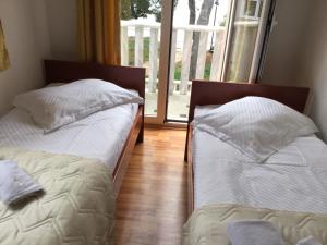 Postel nebo postele na pokoji v ubytování Apartments Šulekić
