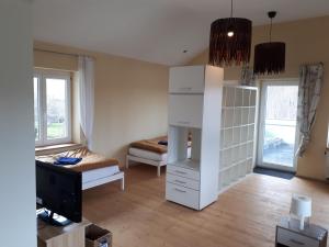 a room with a bedroom with a bed and a tv at Gästehaus GL in Ellwangen
