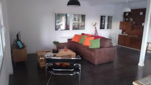 a living room with a couch and a table at Piedra Libre Apartamentos in Manzanares el Real
