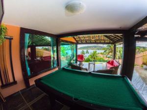a billiard room with a pool table in a house at Mansão Cinematográfica de Frente para à Praia da Ferradura com Sete Suítes Por Luxury Rentals in Búzios