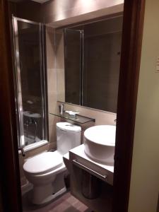 a bathroom with a toilet and a sink and a shower at El Colorado Habitamar in El Colorado