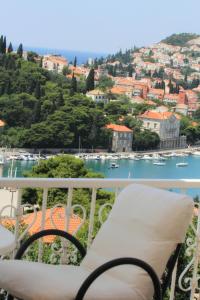 a balcony with a chair and a view of the water at Guesthouse Victoria in Dubrovnik
