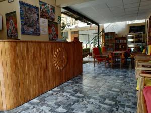a library with a wooden counter and tables and chairs at Hospedaje Inti in Pisac