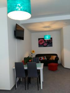 a living room with a table and a couch at City Wohnung Mozart in Saarbrücken