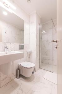 a bathroom with a toilet and a sink and a shower at Sky Corner Hotel in Ohrid