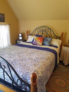 a bedroom with a large bed with pillows on it at Cabin Sweet Cabin in Canyon Lake