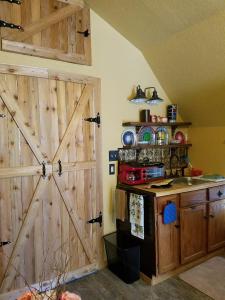 a kitchen with a large wooden door in a room at Cabin Sweet Cabin in Canyon Lake +10 photos