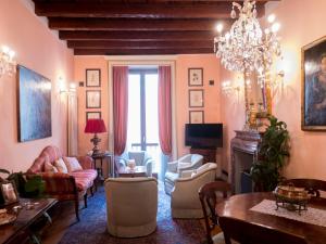 a living room filled with furniture and a chandelier at Broletto 26 in Milan