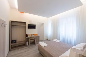 a bedroom with a bed and a desk and a television at SAN FELICE 135 - 2 in Bologna