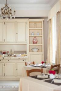 a kitchen with a table and chairs and a cabinet at Villa Cristina in Castellina in Chianti