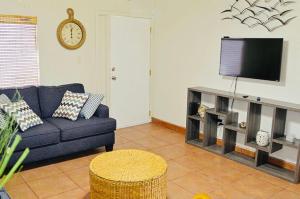 a living room with a blue couch and a tv at Villa in Tranquil Gated Community, 2 Bedroom 2 Bath in Puerto Peñasco
