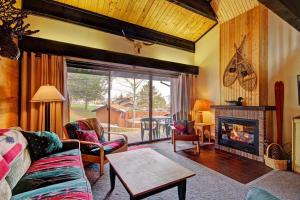 a living room with a couch and a fireplace at Herbage E1 Townhouse Close to City in Steamboat Springs