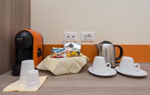 a table with plates and cups and a coffee maker at SAN FELICE 135 - 2 in Bologna