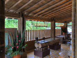 a large wooden pavilion with a table and chairs at Hotel Vísperas in Santa Rosa de Cabal