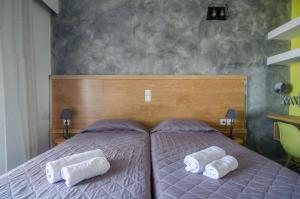 a bedroom with a bed with two pillows on it at Nireas Hotel in Kato Daratso