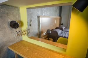 a mirror on the wall of a bedroom with a bed at Nireas Hotel in Kato Daratso