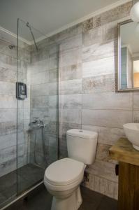 a bathroom with a toilet and a shower and a sink at Nireas Hotel in Kato Daratso