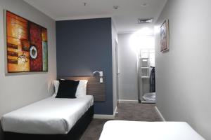 a hotel room with a bed and a desk at 28 Hotel in Sydney