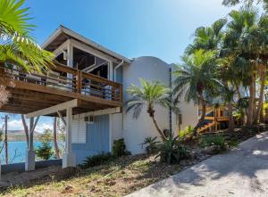 a house on the beach with palm trees at Oceania Villas in Culebra