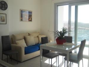 a living room with a couch and a table with chairs at La bella vista in Castelsardo