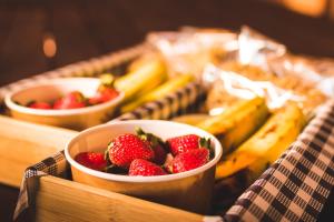 a table topped with bowls of strawberries and bananas at Malanda Lodge in Malanda