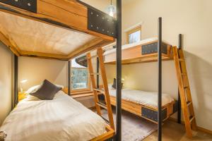 two bunk beds in a small room with two beds at The Mountain Project #2 in Rossland