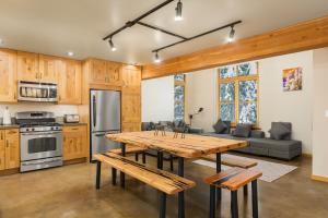a kitchen and living room with a wooden table at The Mountain Project #2 in Rossland