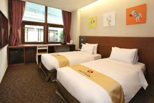 ein Hotelzimmer mit 2 Betten und einem Fenster in der Unterkunft Hotel Skypark Myeongdong 2 in Seoul