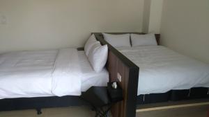A bed or beds in a room at Tropical Fish B&B