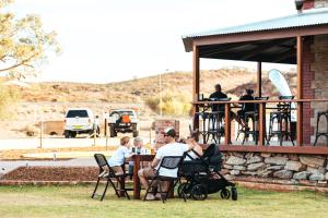 people sitting around a picnic table at Broken Hill Outback Resort in Broken Hill