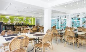 長灘島的住宿－帕緹歐太平洋度假村，一间带桌椅和绿色墙壁的用餐室