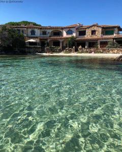 a view of the water in front of a resort at Incanto Apartment Golfo Aranci in Golfo Aranci
