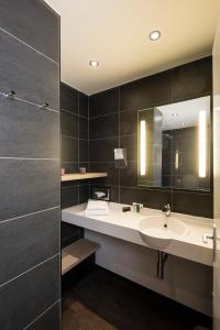 a bathroom with a sink and a mirror at Thalazur Antibes - Hôtel & Spa in Antibes