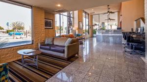 a lobby with a couch and a desk in a building at Best Western Date Tree Hotel in Indio