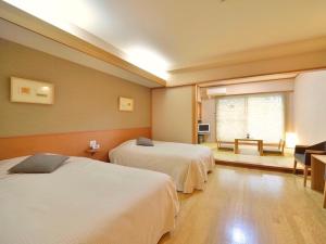 Postel nebo postele na pokoji v ubytování Mashikokan Satoyama Resort Hotel + 37 fotografií