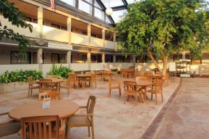 an empty courtyard with tables and chairs in a building at Clarion Inn in Appleton