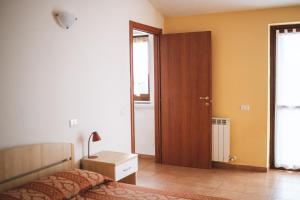 a bedroom with a bed and a closet and a door at Hotel Ristorante Mira Conero in Porto Recanati