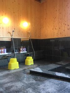 a bathroom with two yellow toilets in a room at Hoshi Meguri in Shimoda